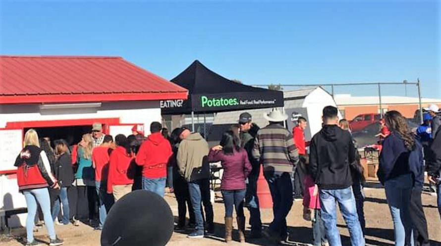 Colorado Potato Administrative Committee talks to spectators about benefits of potatoes at football game