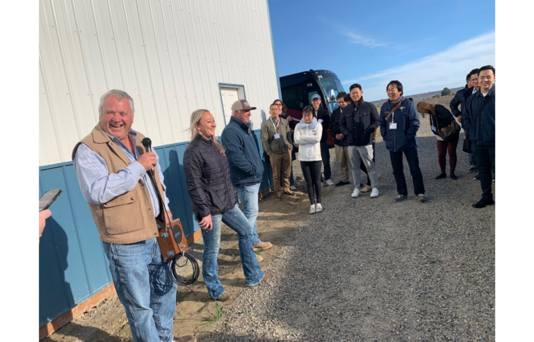 group visits a farm in WA and circles around the tour guides